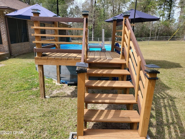 exterior space with fence and a lawn