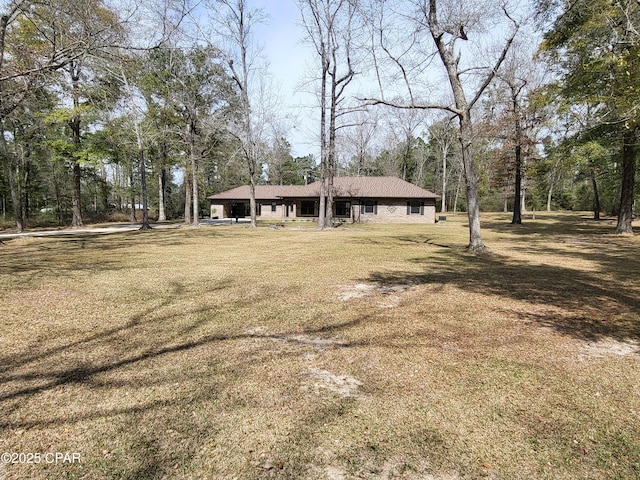 exterior space with a carport and a front yard