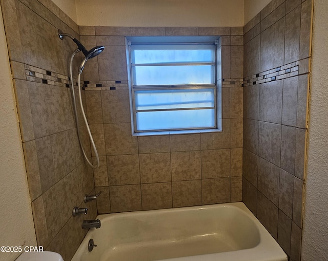 bathroom with bathing tub / shower combination