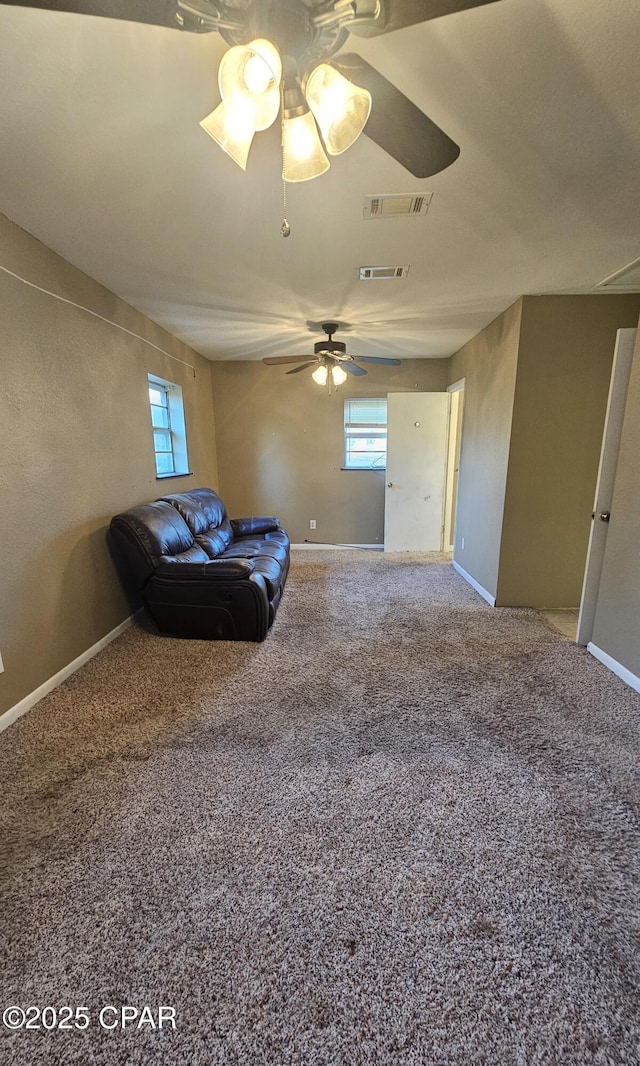 unfurnished living room with carpet floors, visible vents, and plenty of natural light