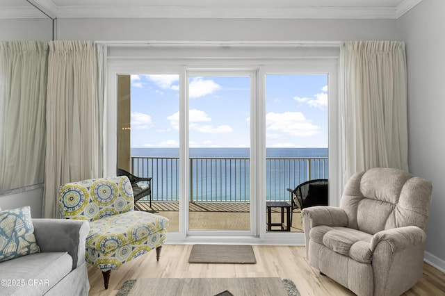 interior space featuring ornamental molding, a water view, and wood finished floors