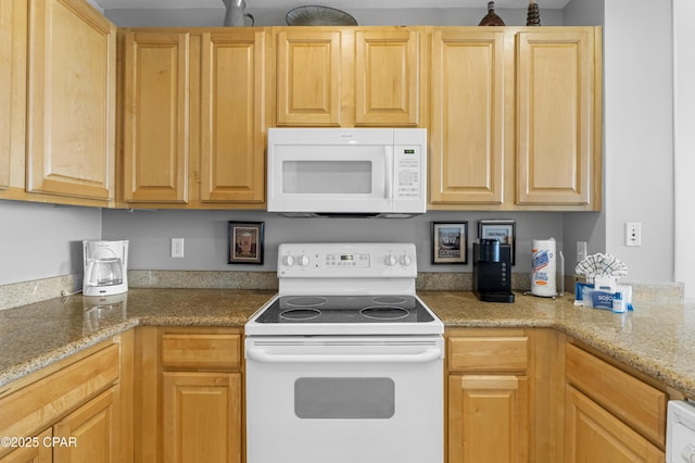 kitchen with light stone countertops, white appliances, and light brown cabinetry