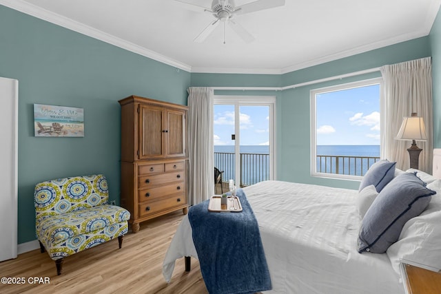 bedroom featuring light wood-type flooring, access to outside, a water view, and crown molding