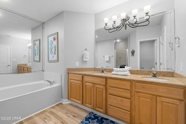 full bath with double vanity, a sink, and a shower stall