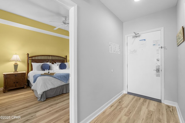 entrance foyer featuring ceiling fan, light wood finished floors, and baseboards