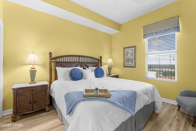 bedroom with ceiling fan, baseboards, and wood finished floors