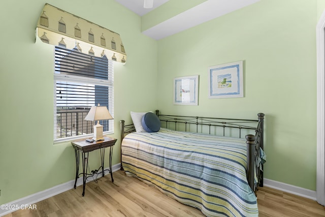 bedroom featuring wood finished floors and baseboards