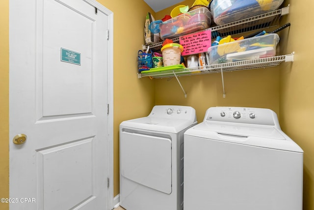 washroom with laundry area and washer and dryer