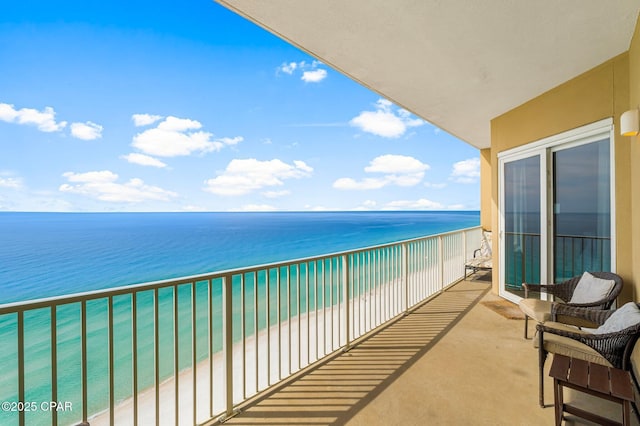 balcony with a water view and a beach view