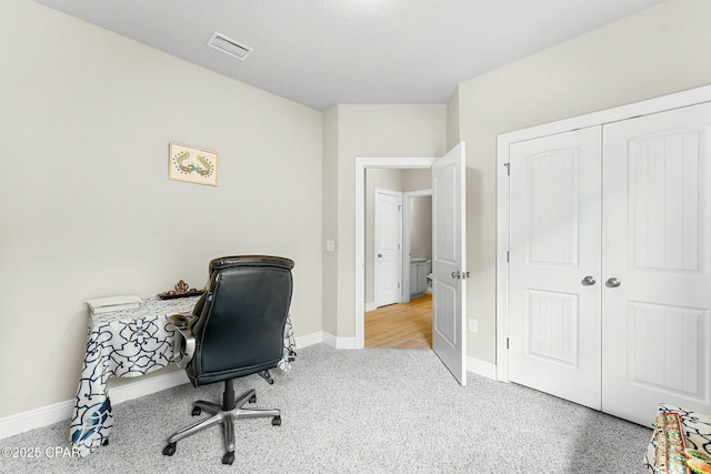 carpeted home office with baseboards and visible vents