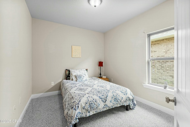 carpeted bedroom featuring baseboards