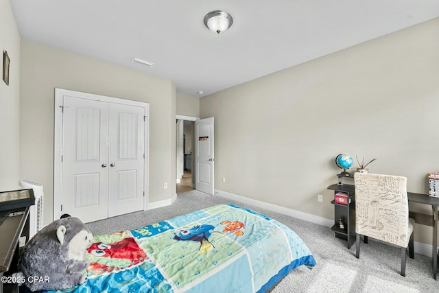 carpeted bedroom featuring visible vents, baseboards, and a closet