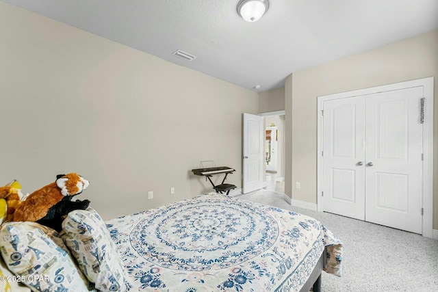 bedroom with a closet, light carpet, visible vents, and baseboards