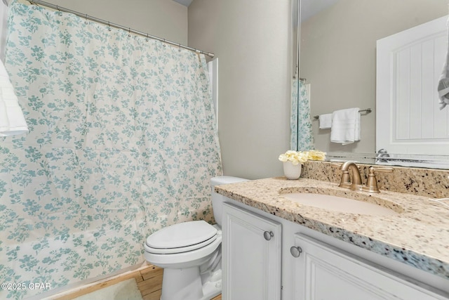 full bathroom with wood finished floors, curtained shower, vanity, and toilet