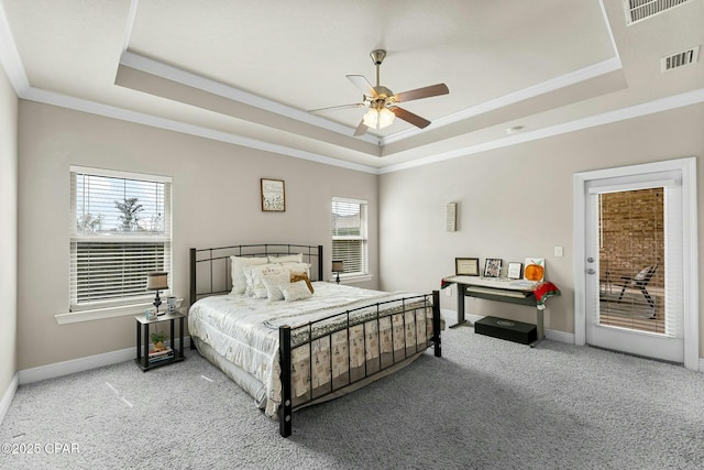 bedroom featuring carpet floors, a raised ceiling, visible vents, and baseboards