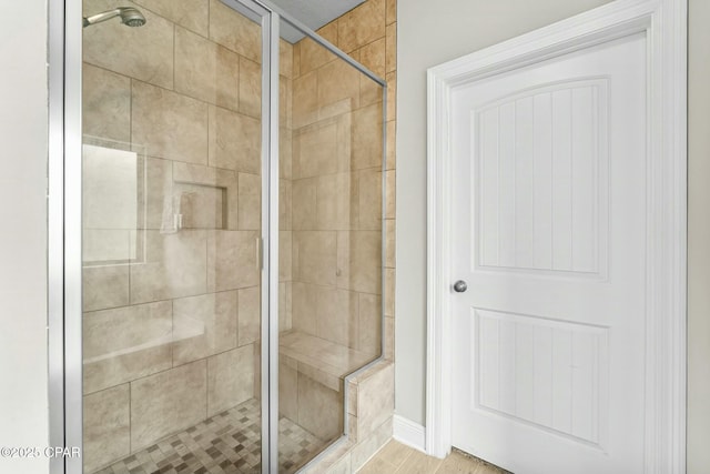 full bath with a shower stall