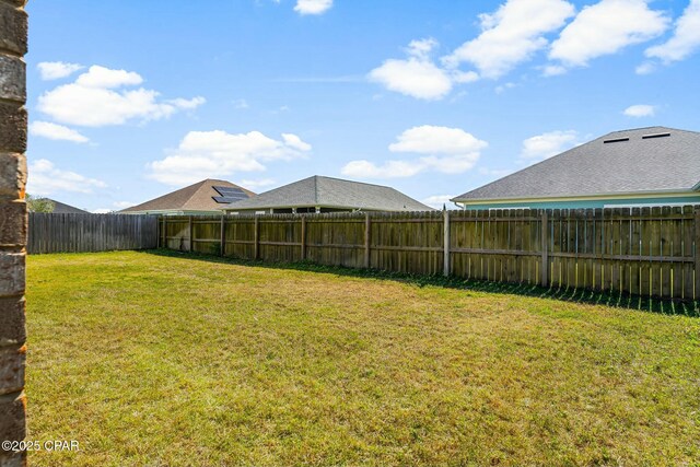 view of yard with a fenced backyard