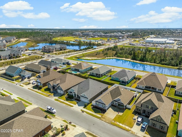 drone / aerial view featuring a water view and a residential view