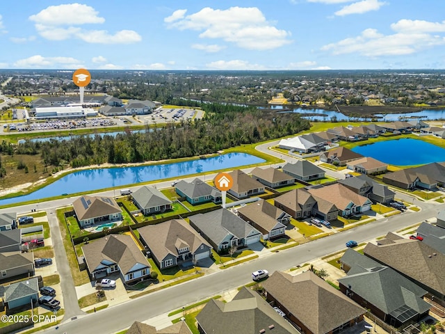 birds eye view of property with a water view and a residential view