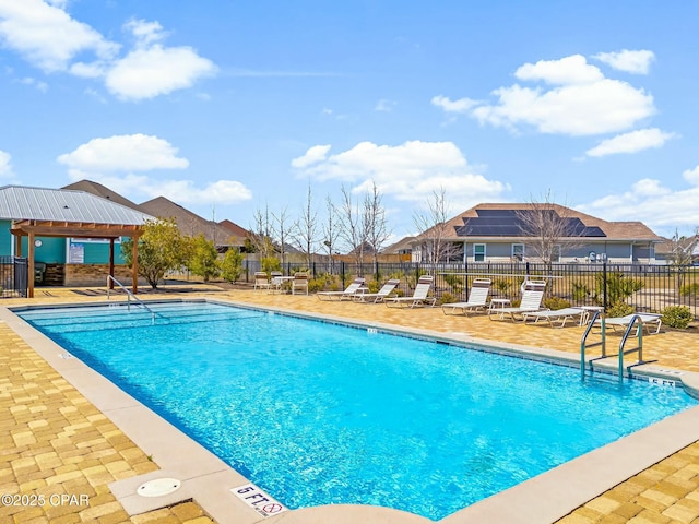 pool with a gazebo, a patio area, and fence