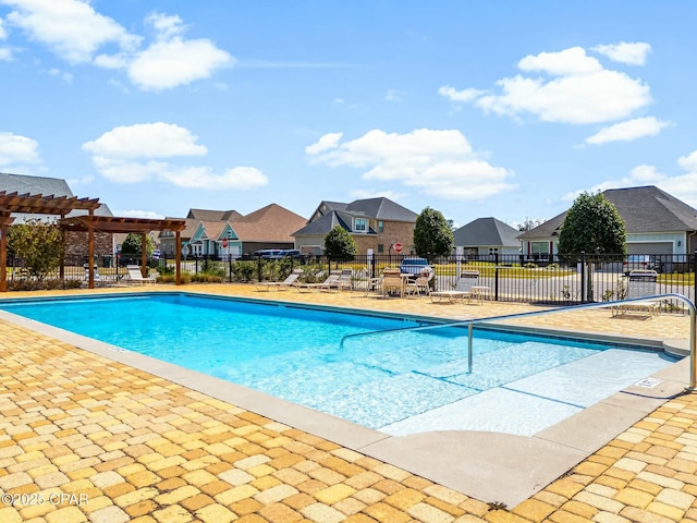 pool with a residential view, a patio area, fence, and a pergola