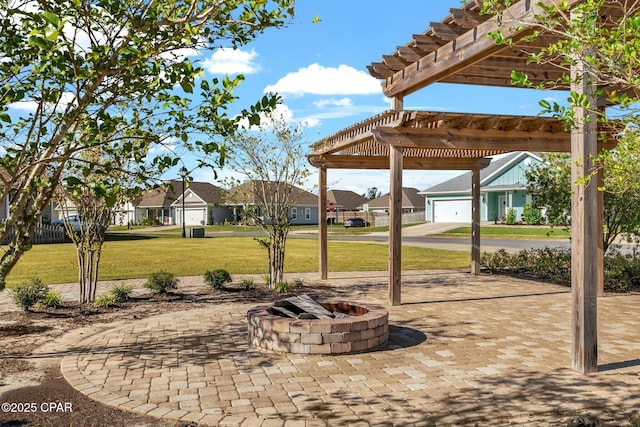 view of patio / terrace with a residential view, a fire pit, and a pergola