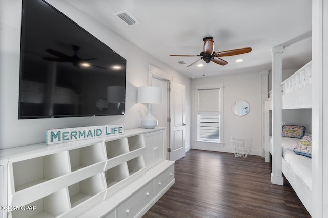 corridor featuring dark wood finished floors, recessed lighting, visible vents, and baseboards