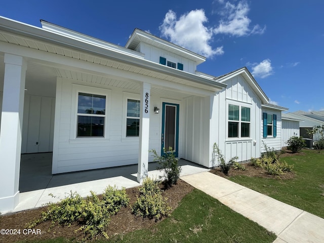 view of front facade featuring covered porch and board and batten siding