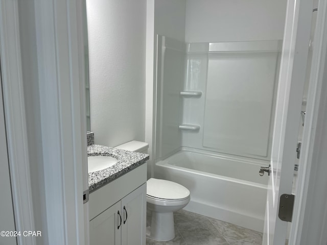 bathroom featuring shower / washtub combination, vanity, toilet, and tile patterned floors