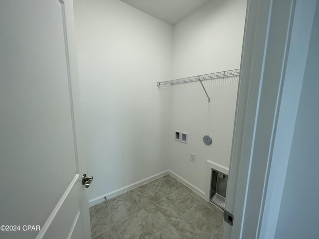 clothes washing area with laundry area, hookup for a washing machine, electric dryer hookup, and baseboards