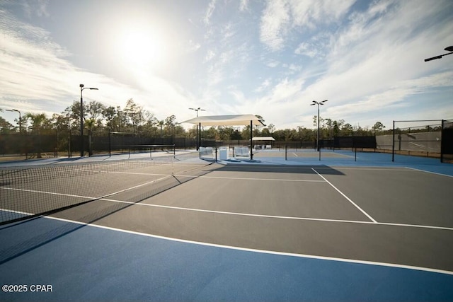 view of tennis court featuring fence