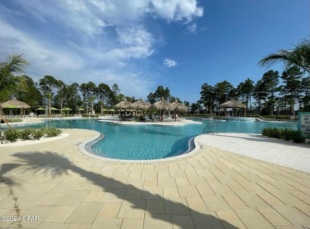 community pool with a patio area and a gazebo