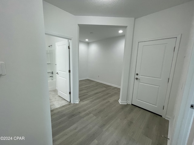 interior space with wood finished floors and baseboards