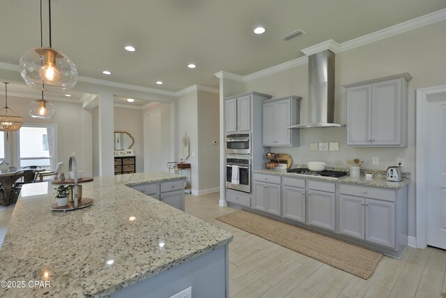 146 Bayou Manor Rd, Santa Rosa Beach, FL 32459 - kitchen featuring wall chimney exhaust hood, light stone countertops, gray cabinetry, light wood-style flooring, and visible vents