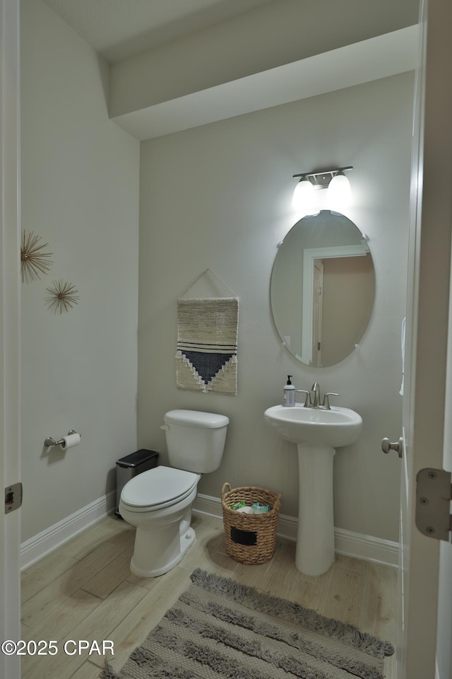 146 Bayou Manor Rd, Santa Rosa Beach, FL 32459 - bathroom featuring baseboards, wood finished floors, and toilet