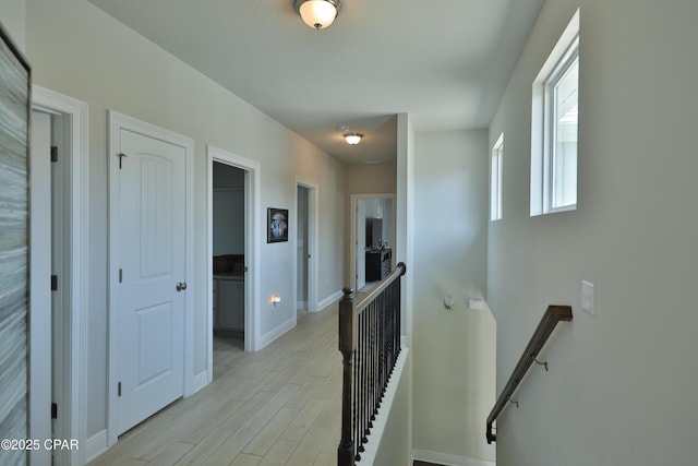 146 Bayou Manor Rd, Santa Rosa Beach, FL 32459 - corridor with baseboards, an upstairs landing, and light wood-style floors