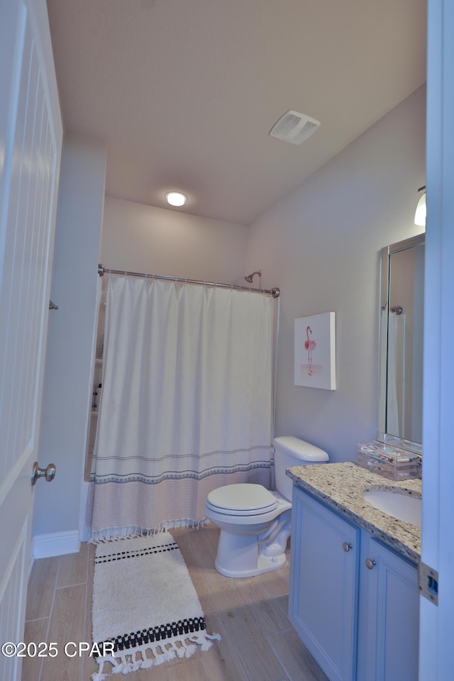 146 Bayou Manor Rd, Santa Rosa Beach, FL 32459 - bathroom with toilet, curtained shower, vanity, wood finished floors, and visible vents