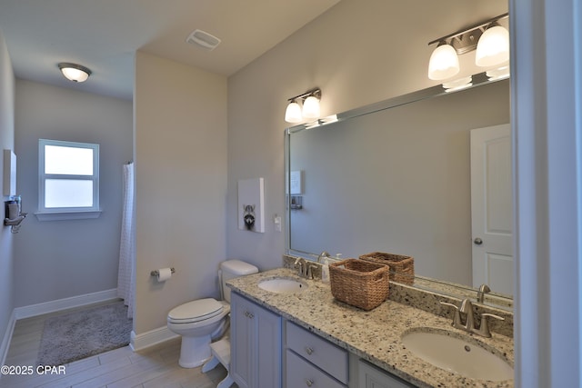 146 Bayou Manor Rd, Santa Rosa Beach, FL 32459 - full bath featuring double vanity, visible vents, a sink, and toilet
