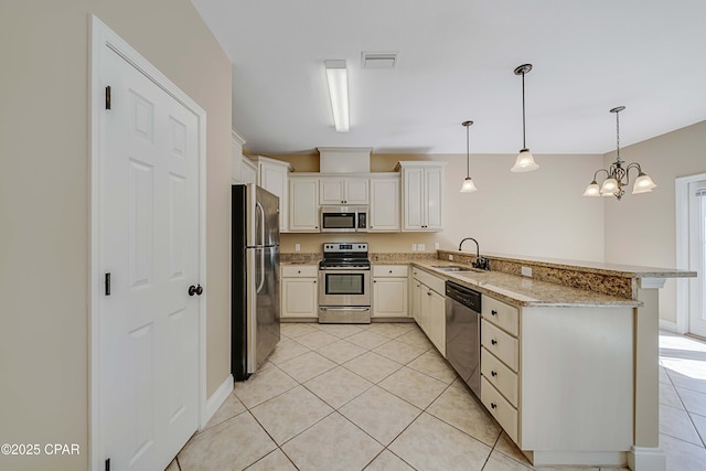 kitchen with a sink, light tile patterned flooring, visible vents, a peninsula, and appliances with stainless steel finishes