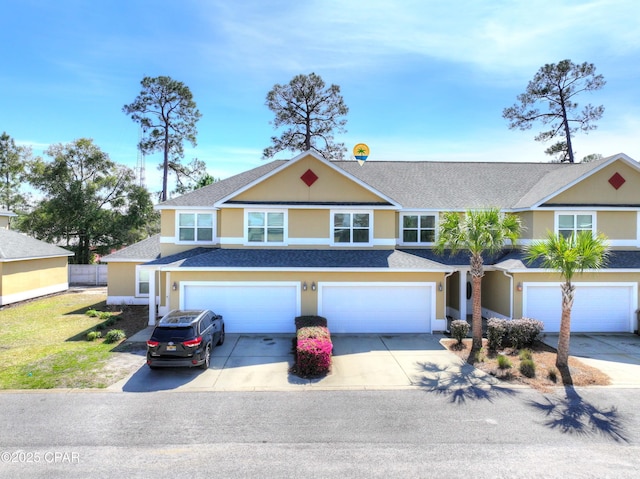 multi unit property featuring driveway, a shingled roof, an attached garage, and stucco siding