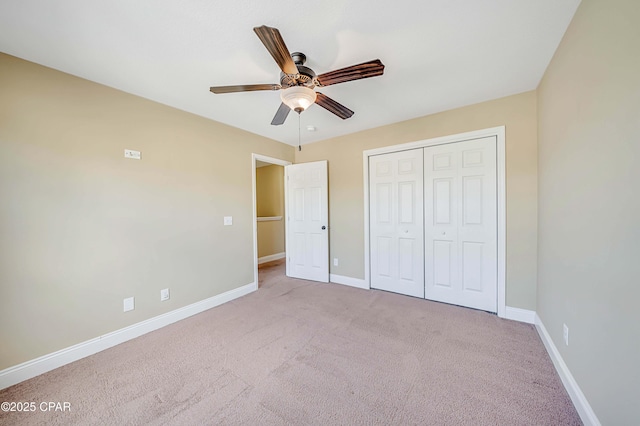 unfurnished bedroom featuring carpet floors, a closet, and baseboards