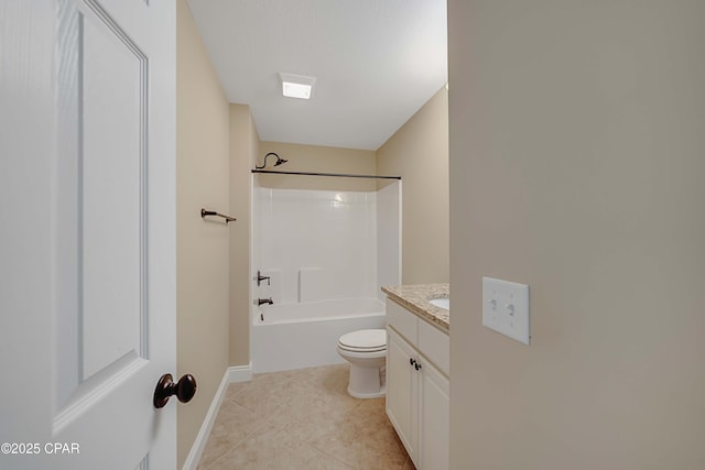 bathroom featuring tile patterned floors, toilet, vanity, baseboards, and washtub / shower combination
