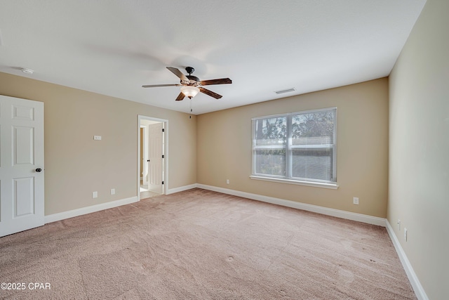 empty room with a ceiling fan, visible vents, carpet floors, and baseboards