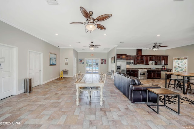 living area with recessed lighting, stone finish floor, ornamental molding, ceiling fan, and baseboards