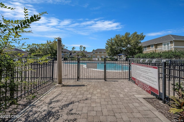 pool featuring a residential view and fence