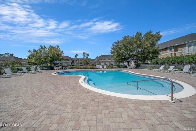 community pool featuring a patio, a gazebo, and fence
