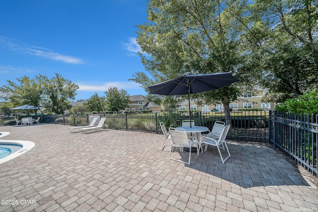 view of patio / terrace with outdoor dining area, a swimming pool, and fence
