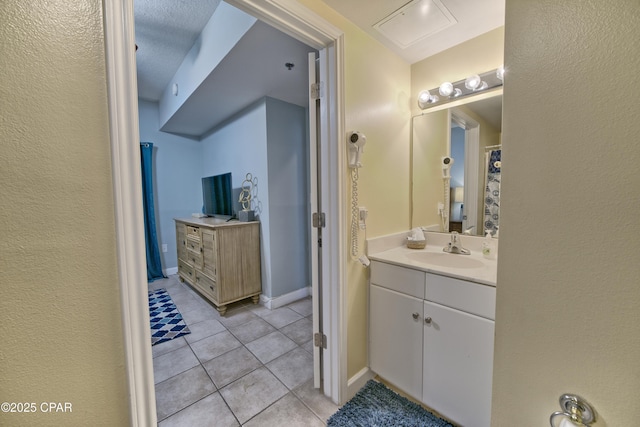 full bath with tile patterned floors, baseboards, and vanity