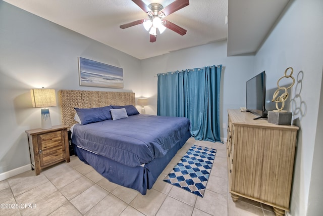 bedroom featuring light tile patterned floors, ceiling fan, and baseboards