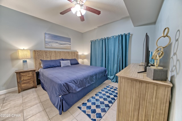 bedroom featuring ceiling fan, baseboards, and light tile patterned flooring